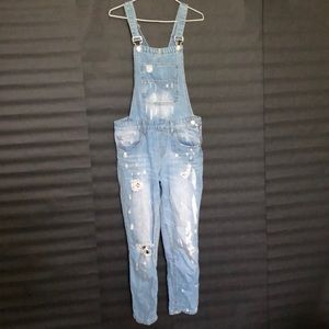 Light-washed distressed overalls